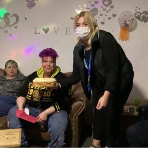 Resident receiving birthday cake