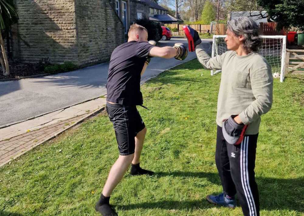2 residents boxing outdoors