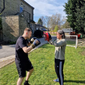 two residents boxing outdoors