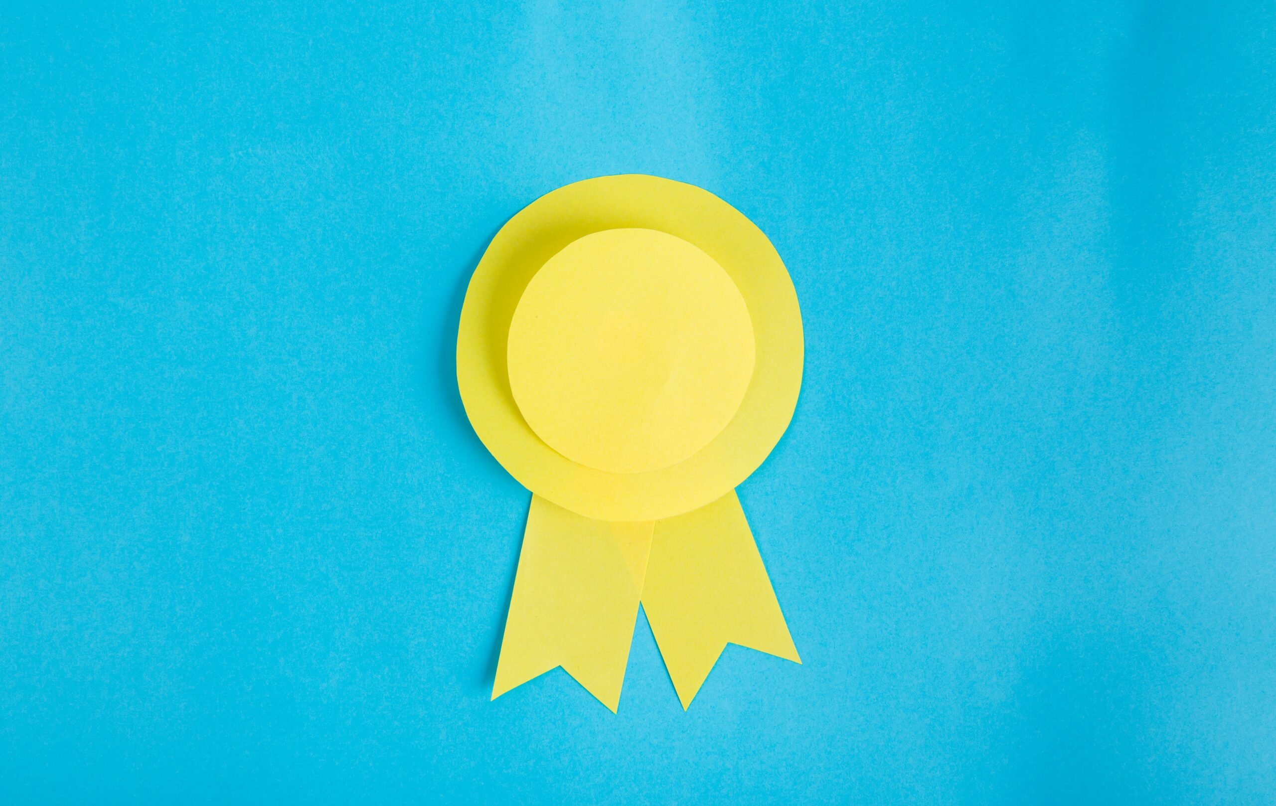 yellow award ribbon on light blue background