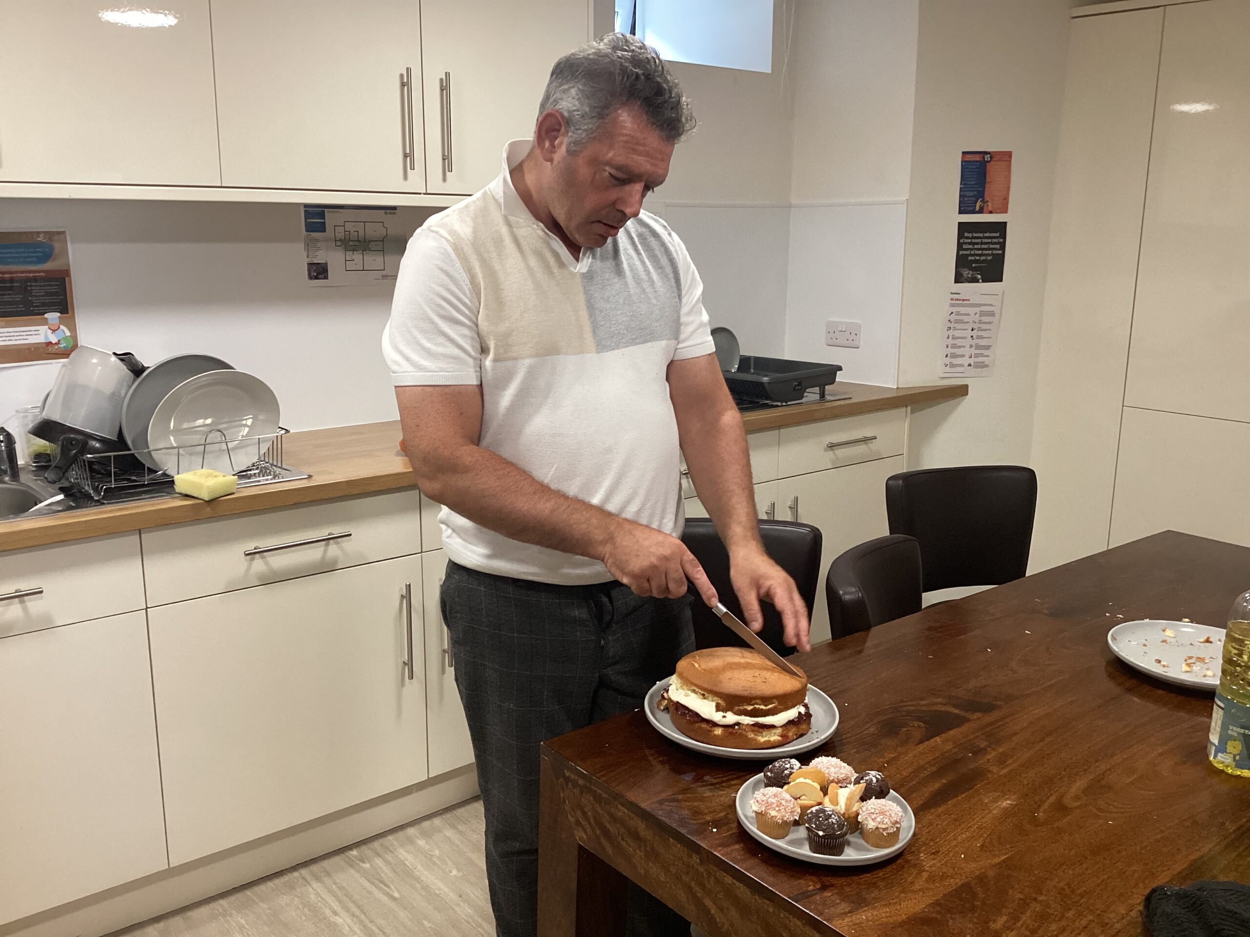 resident cutting homemade cake