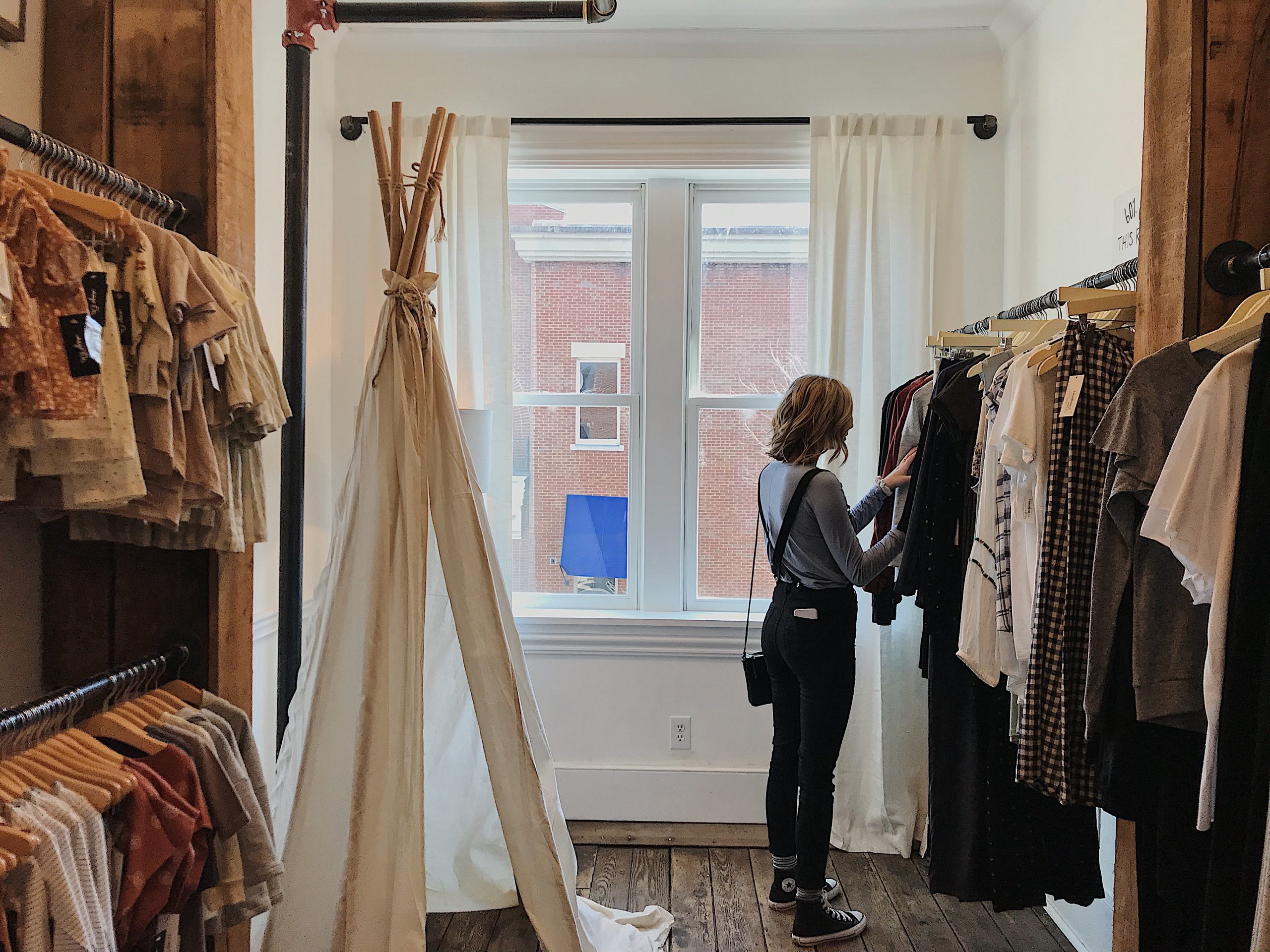 woman browsing through clothing rail