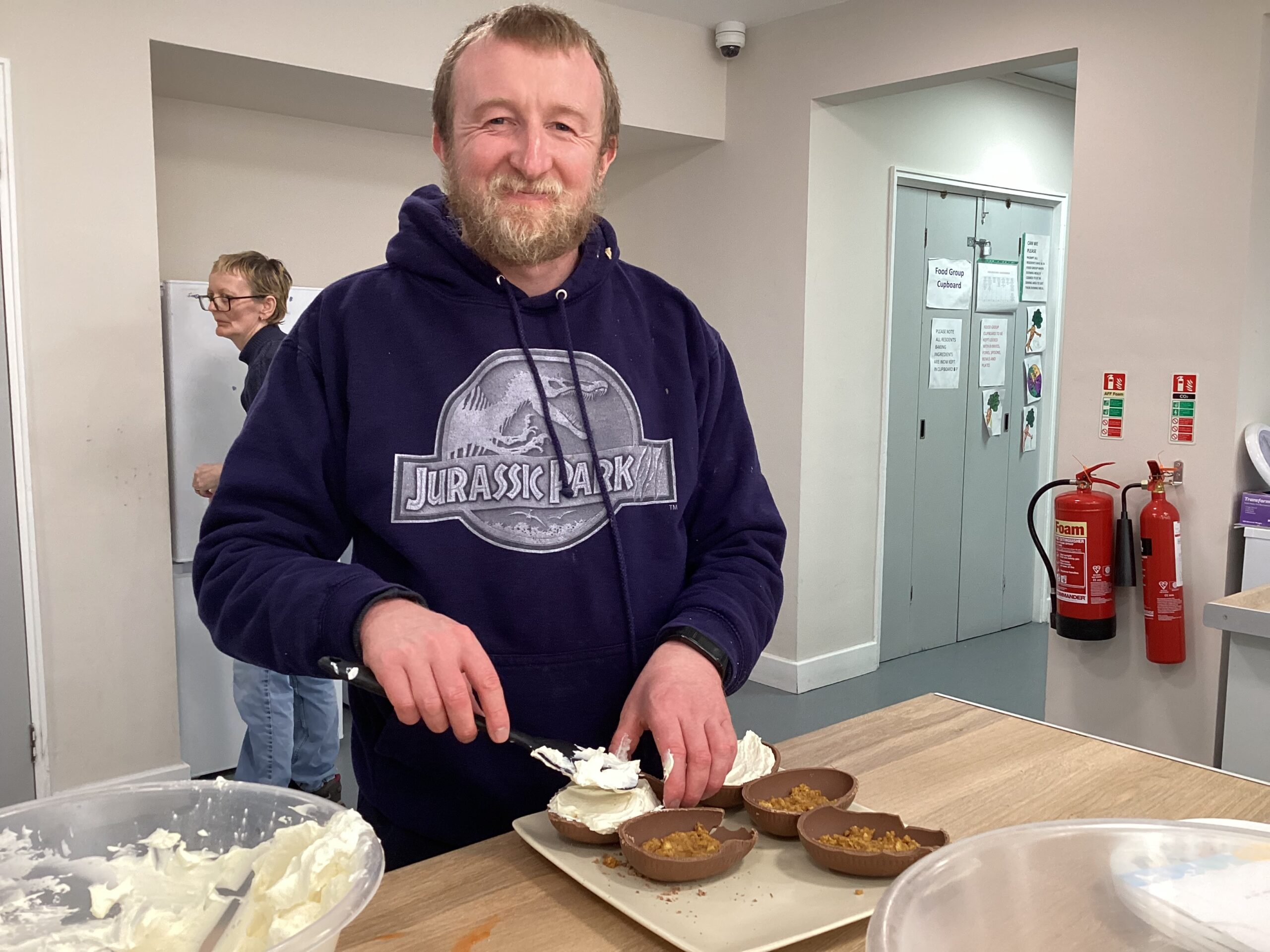 Resident filling an Easter egg with cheesecake mix