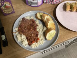 plate of chilli and rice with garlic bread