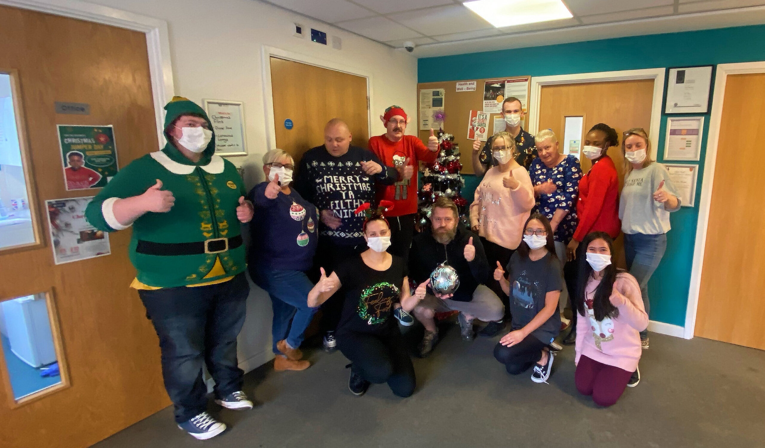 Residents and team members group picture wearing christmas jumpers