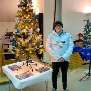 resident next to christmas tree