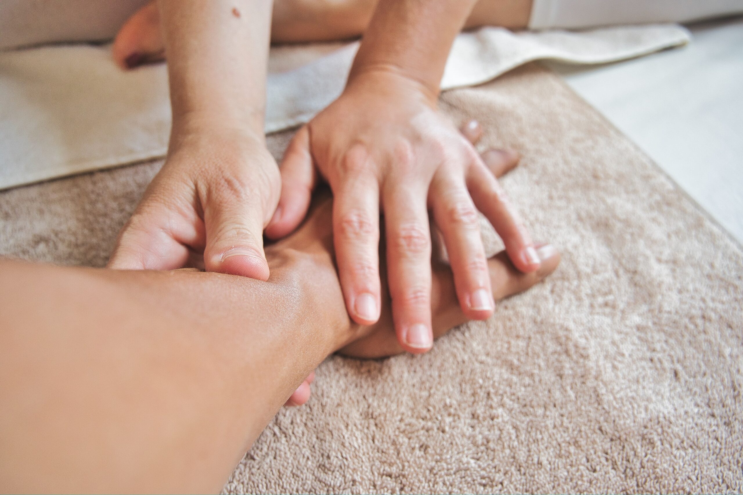 two hands holding an arm