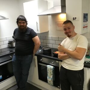 2 male residents in kitchen