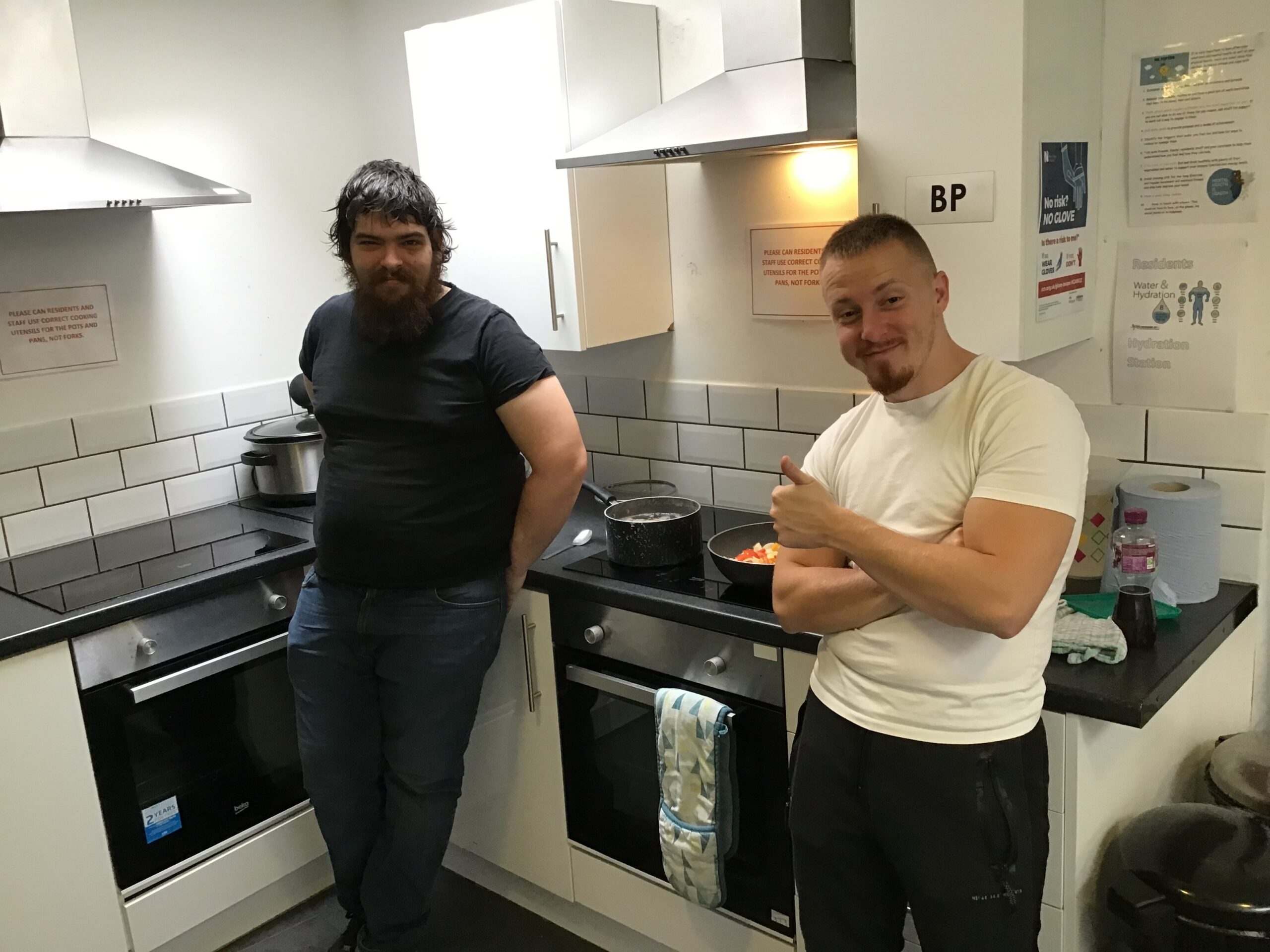 2 male residents in kitchen