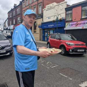 resident holding tray of cupcakes