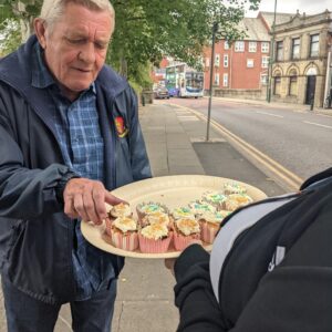 resident handing out cupcakes