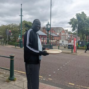 resident holding a tray of cupcakes