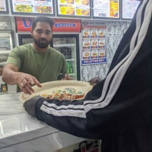 resident handing out cupcakes to local businesses