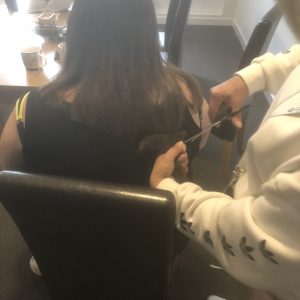 resident getting hair cut for little princess trust