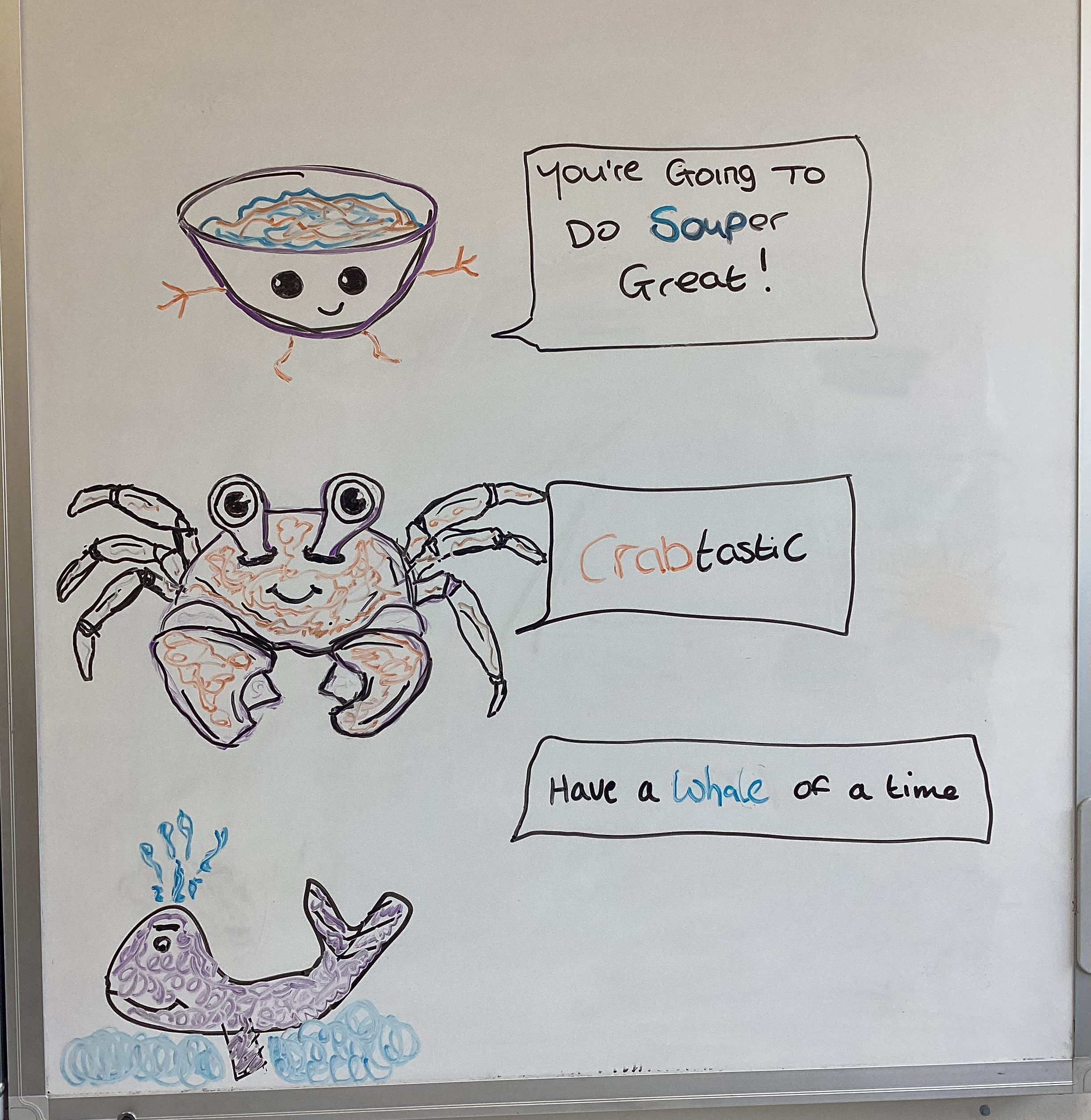 whiteboard with drawings of bowl of soup, crab and whale, and positive quote written next to the drawings