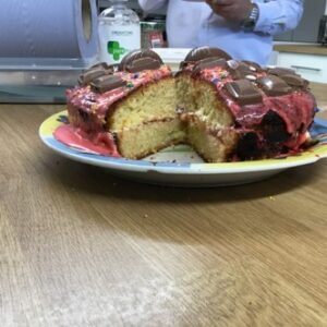 easter cake with red icing and slice taken out