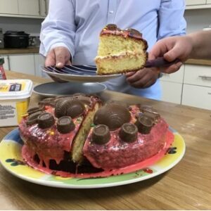 slicing an easter cake with red icing