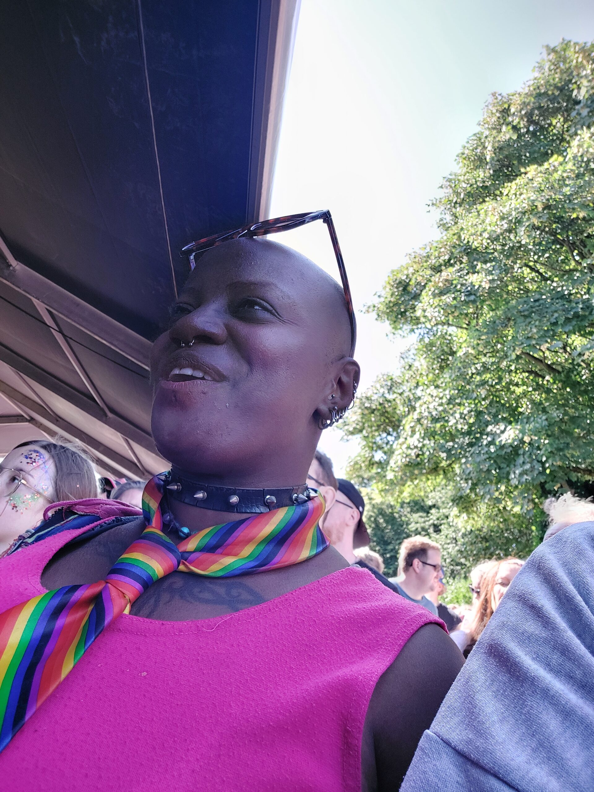 resident in pink top and rainbow scarf at festival