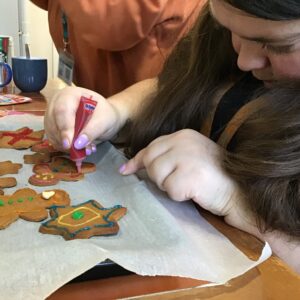 resident decorating gingerbread with icing