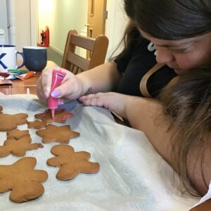 resident decorating gingerbread with icing