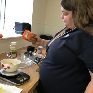resident pouring ingredients into a bowl
