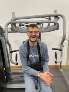 resident at gym on chest press machine