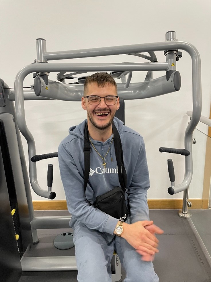 resident at gym on chest press machine