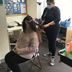 Team member styling residents hair