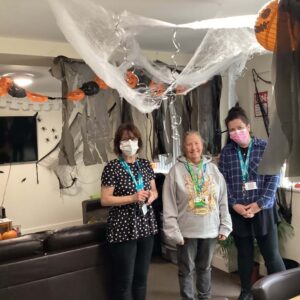 Resident and team member proudly displaying their Halloween decorations