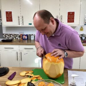 resident carving pumpkin