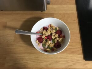 birds eye view of bowl with fruit, yoghurt and granola