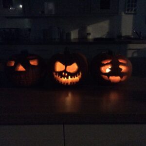 carved pumpkins lit up in the dark