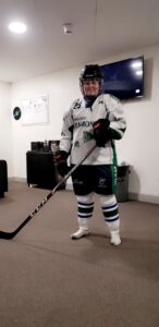 resident dressed in ice hockey kit holding hockey stick