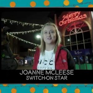 team member at christmas lights switch on