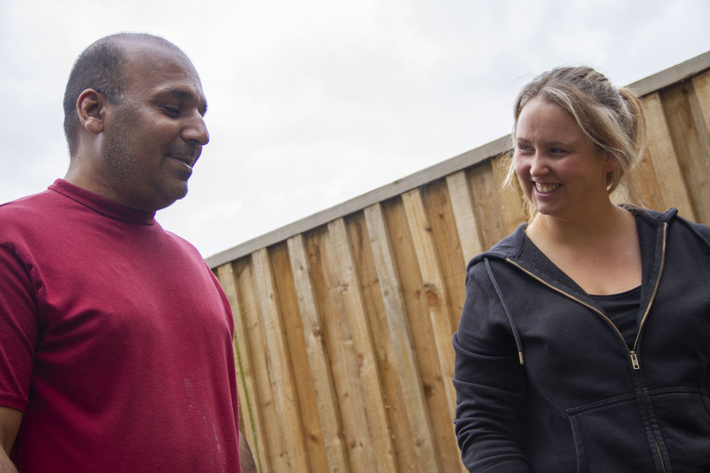 resident and team member smiling at each other in garden