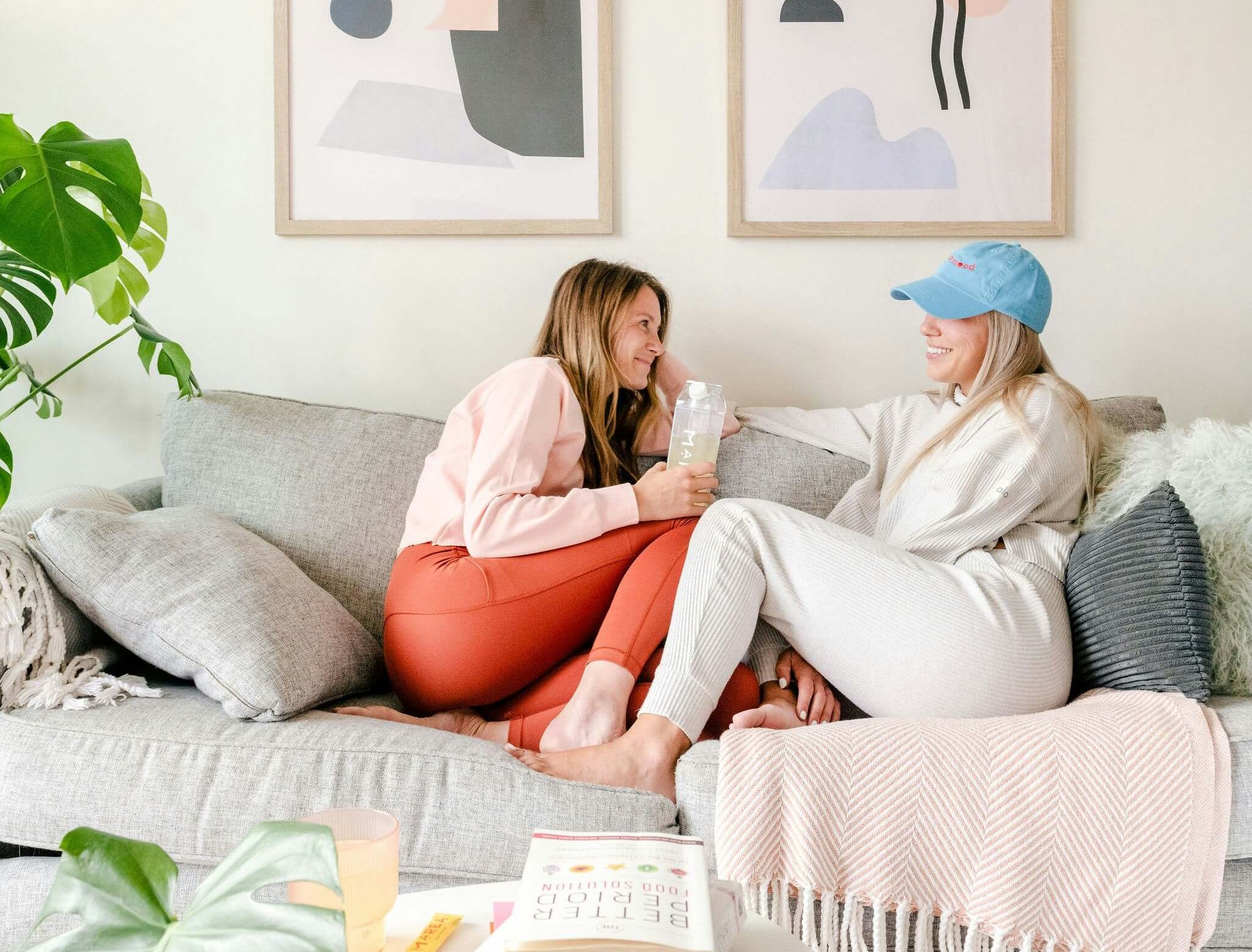 Two girls relaxing at home highlighting the psychological benefits our environment can have on our mental health.
