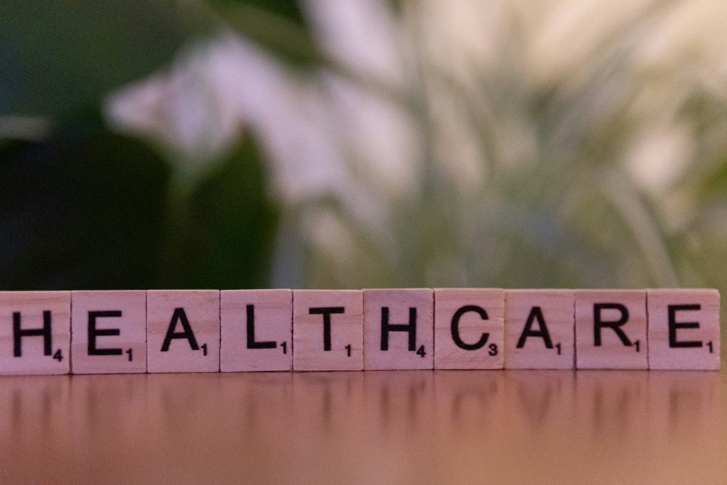 Scrabble tiles spelling HEALTHCARE on a table