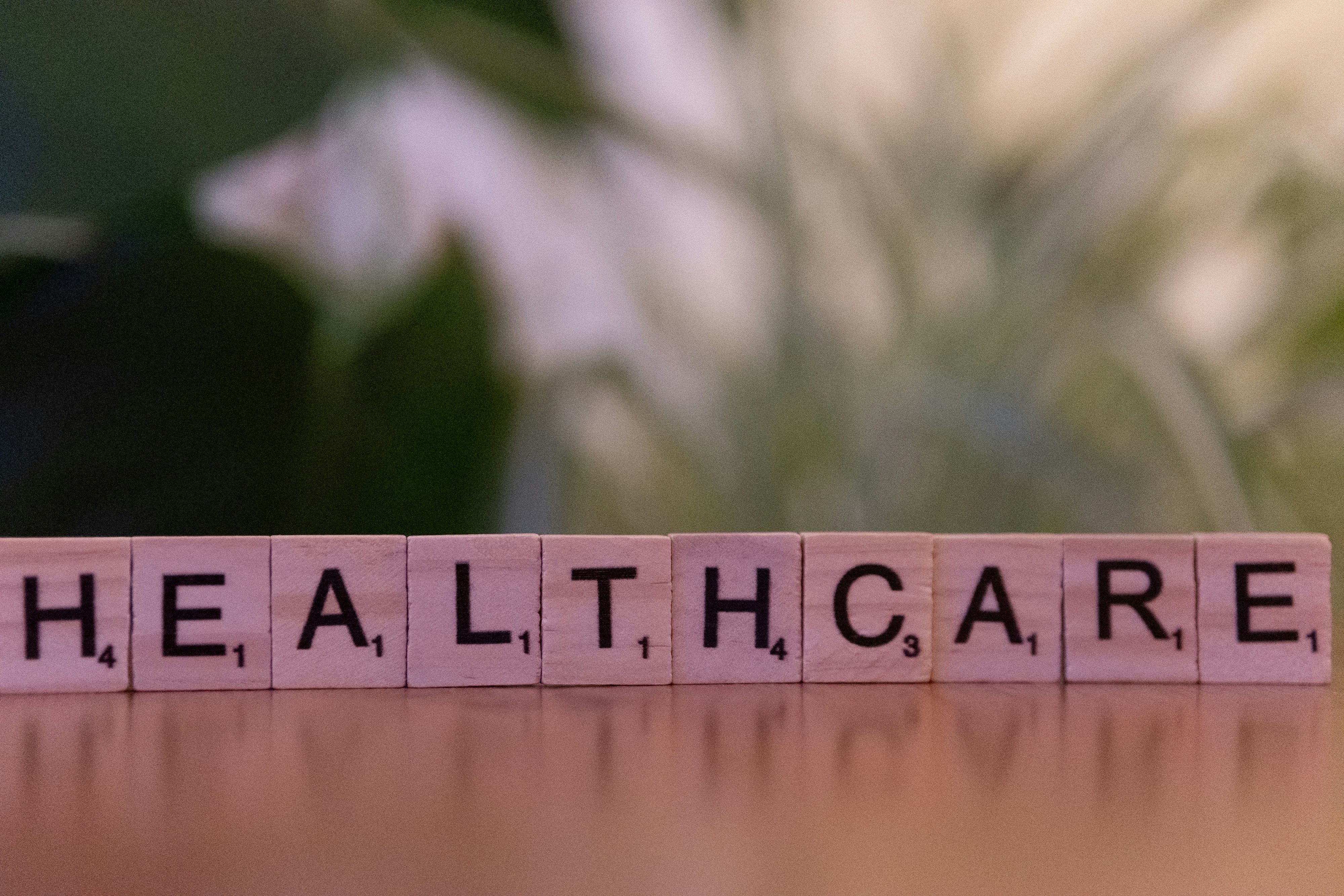 Scrabble tiles spelling HEALTHCARE on a table