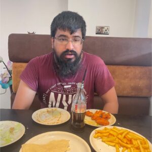 resident wearing purple top enjoying meal