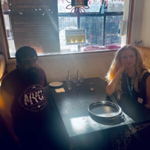 resident at team member at table in restaurant