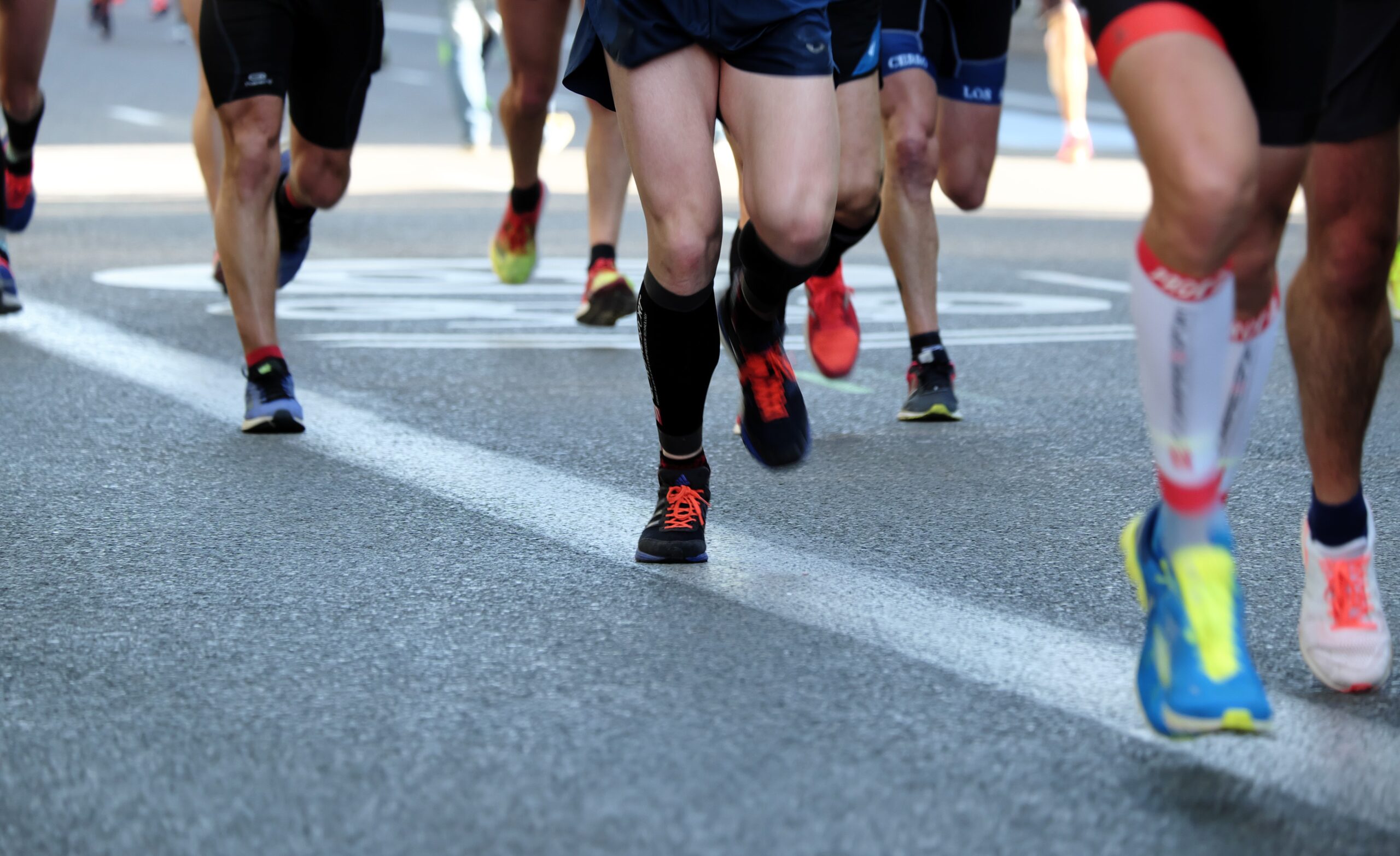 the legs of a group of runners
