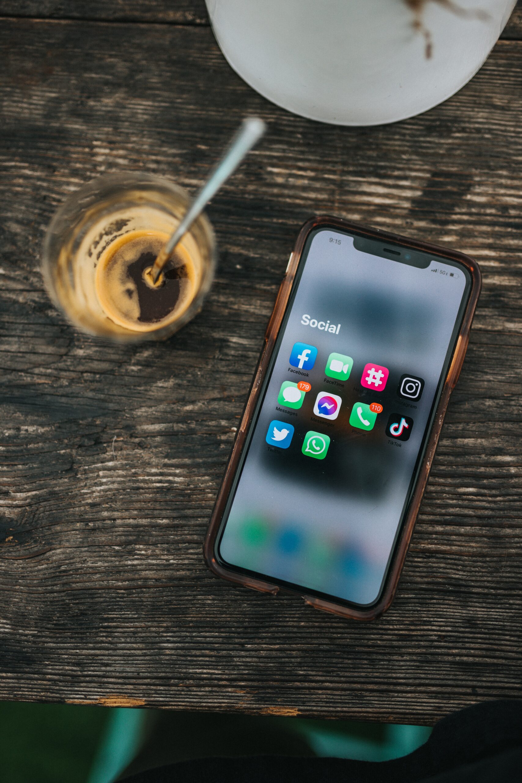 social media influence: cup of coffee and phone on table displaying social media apps