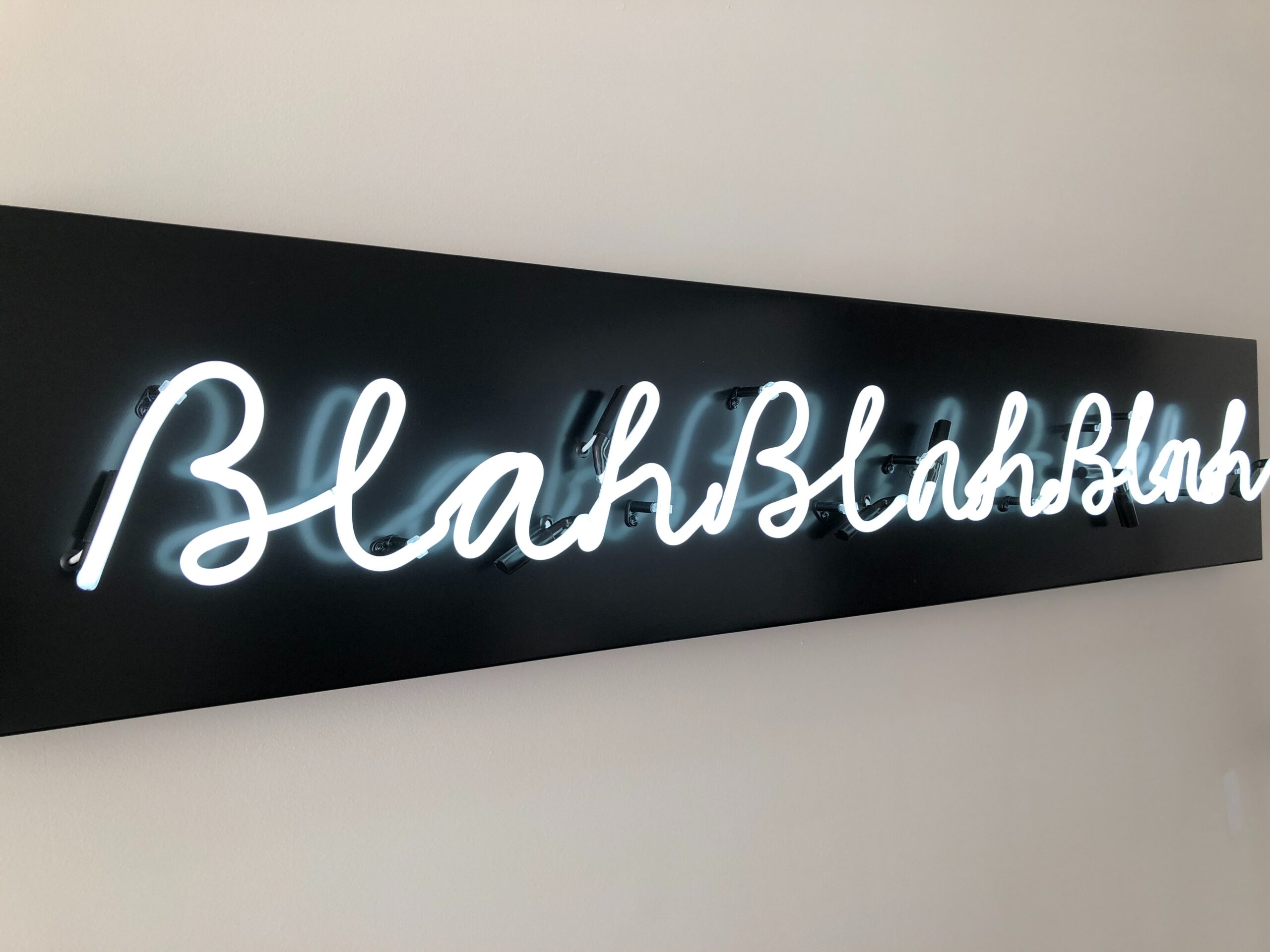 sign that reads "blah blah blah" in blue lighting