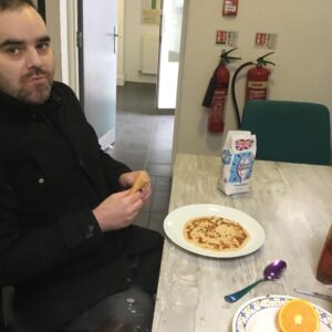 male resident eating pancake