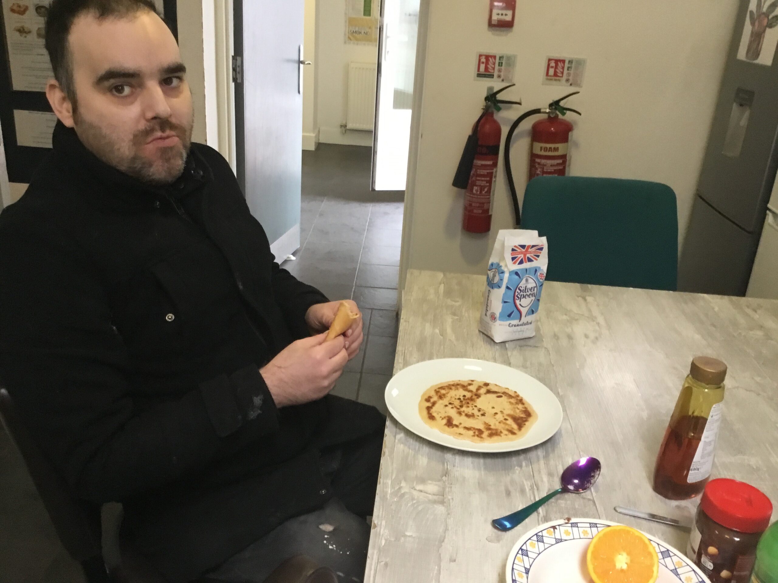 male resident eating pancake