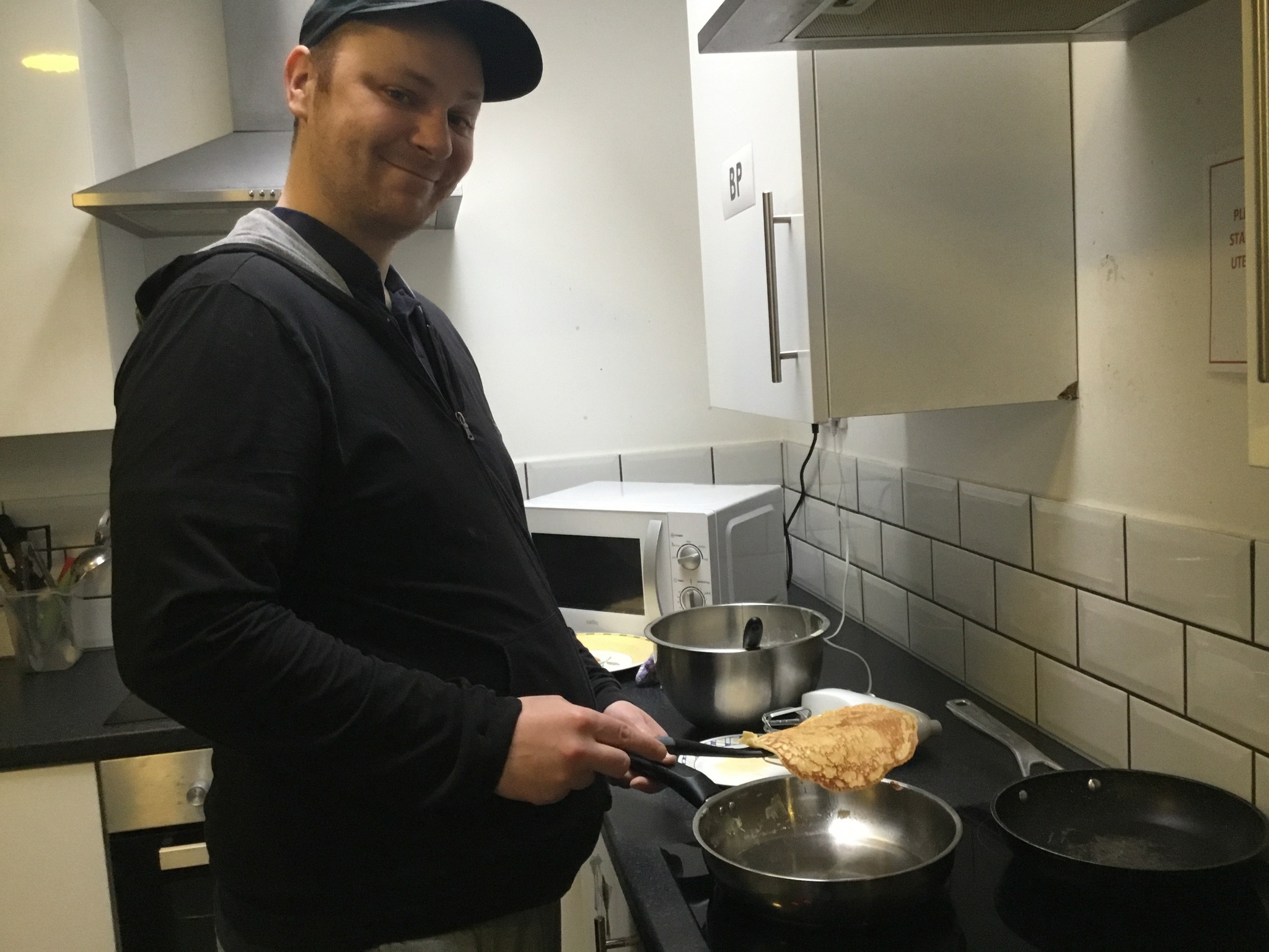 Male resident making pancakes