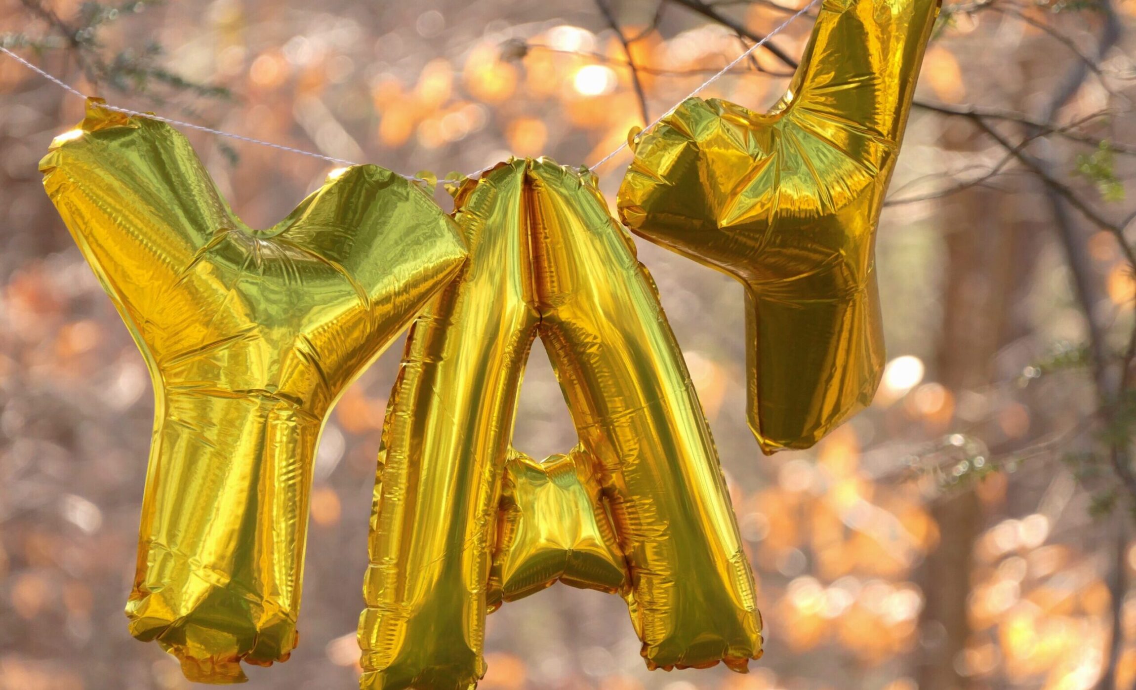 gold balloons spelling YAY