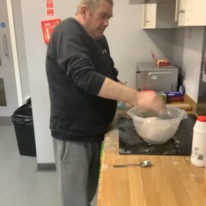 male resident making pizza dough
