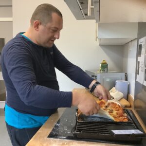 male resident making pizza