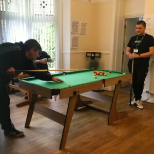 Two residents playing pool